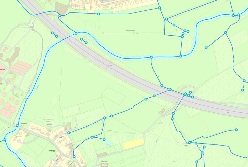 An example map showing the HydroNode feature which explicitly represents the source, sink or junction of a watercourse. All watercourses on the map extract have white circles with a solid blue outline on them at various points to represent the HydroNode feature.